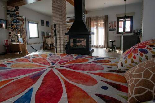 a living room with a bed and a fireplace at La Cambra casa rural in Potríes