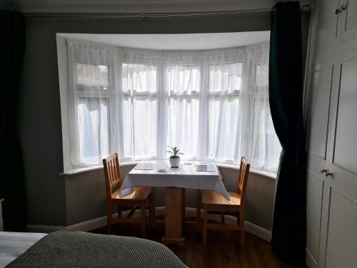 a table and chairs in a room with a window at The Golf Studio Woodhall Spa in Woodhall Spa
