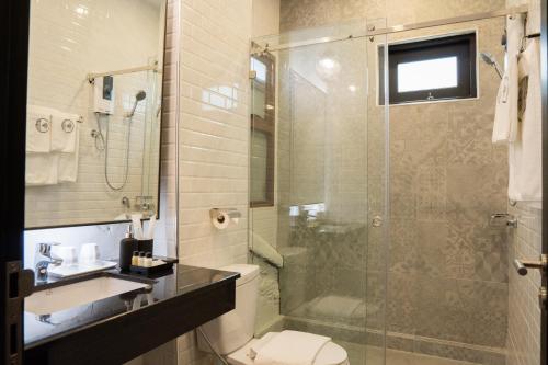 a bathroom with a shower and a toilet and a sink at BAAN 125 STAY Phuket in Phuket Town