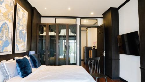 a bedroom with a bed with blue pillows at BAAN 125 STAY Phuket in Phuket Town