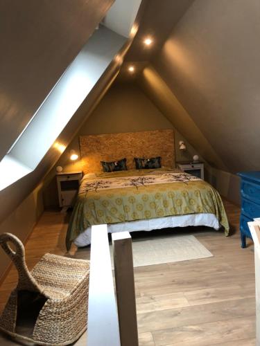 a bedroom with a bed in a attic at L Atypik à L ancienne forge in Muhlbach-sur-Munster