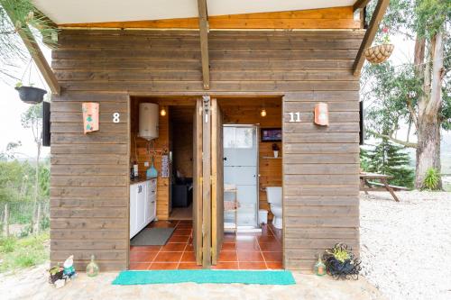 a tiny house with a kitchen in the middle at Moinho da Amélia in Cadaval