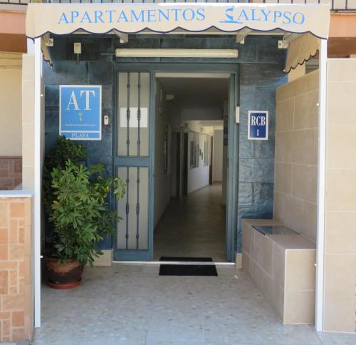 an entrance to an office building with a sign on the door at Apartamentos Calypso in Punta Umbría