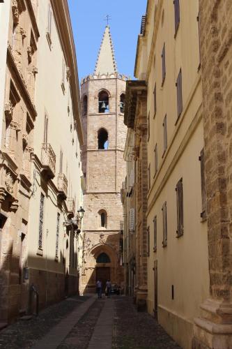 an alley with a clock tower in a building at SoleLunaMare Guest House in Alghero