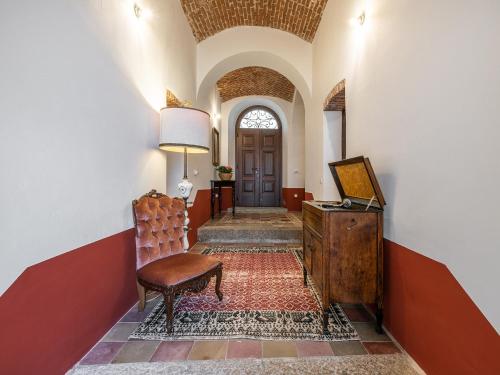 a hallway with a door and a chair and a table at PALAZZO CHERCHI in Dorgali