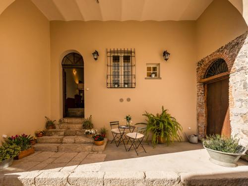 a home with a patio with a table and chairs at PALAZZO CHERCHI in Dorgali