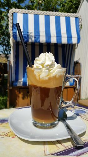 a cup of coffee with whipped cream on a table at Kalmar 8 in Kägsdorf