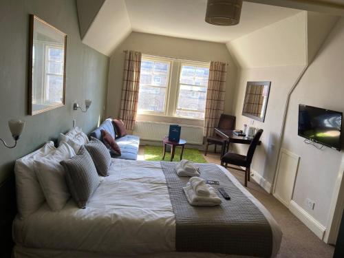 a bedroom with a bed and a living room at The Lambton Arms in Durham