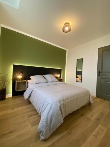 une chambre avec un grand lit avec un mur végétal dans l'établissement Home Sevrier, à Sévrier