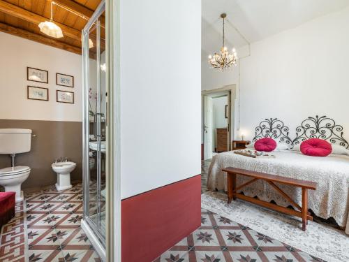 a bedroom with a bed with pink pillows at PALAZZO CHERCHI in Dorgali