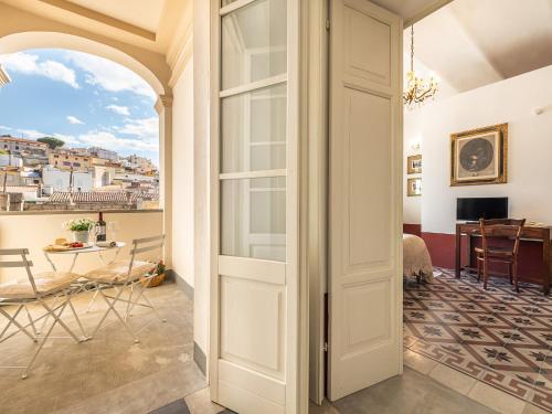 a door to a room with a view of a table at PALAZZO CHERCHI in Dorgali