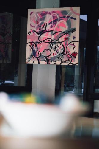 a painting with graffiti on the side of a window at Ibis Styles Toulouse Centre Canal du Midi in Toulouse