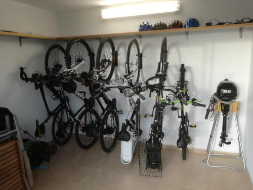 a bunch of bikes are hanging on a wall at Luxury 10-bed villa with view pool playground in Horní Planá