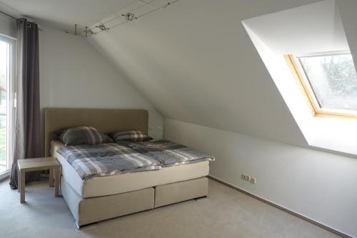 a small bedroom with a bed in a attic at Ferienwohnung Thuja in Wandlitz