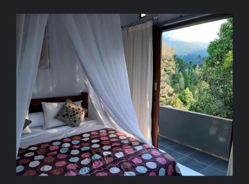 a bedroom with a bed and a large window at Sugi Gede Homestay in Singaraja
