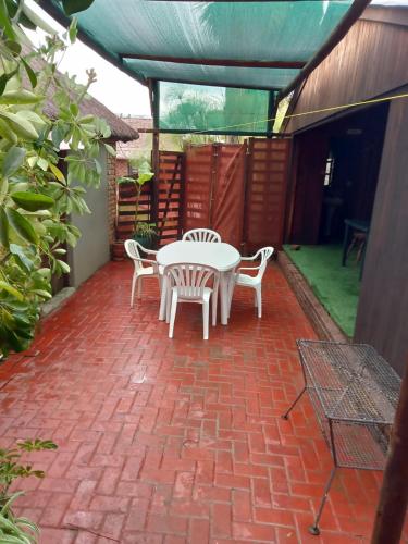 a patio with a table and chairs on a brick patio at Ay Jay's Guesthouse in Bloemfontein