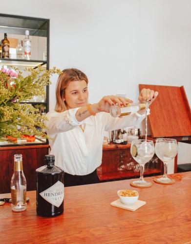 a woman is pouring a glass of wine at Bordoy Mostatxins - Hotel Boutique Adults Only in Alcudia