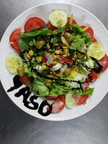 a salad on a white plate on a table at camping yaso-guara in Yaso