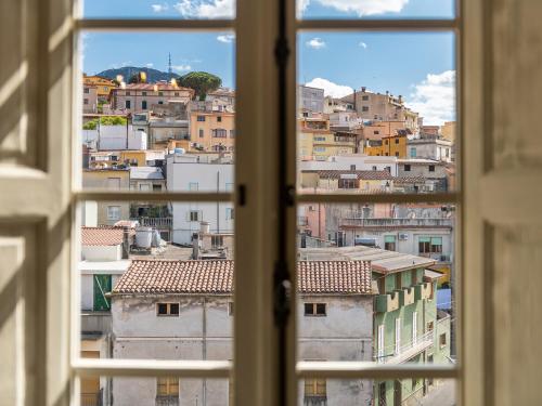 a view of a city from an open window at PALAZZO CHERCHI in Dorgali