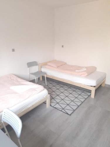two beds sitting next to each other in a room at Noclegi u Andrzeja in Gdańsk
