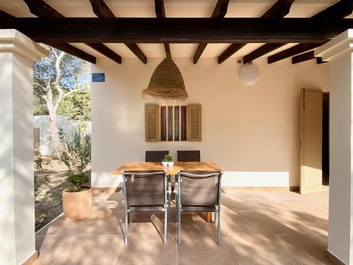a dining room with a table and chairs at Campanitx Villas - Astbury Formentera in Es Caló