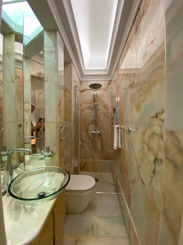 een badkamer met een wastafel, een toilet en een douche bij OHH -Oporto Center- Luxury Apartment in Porto