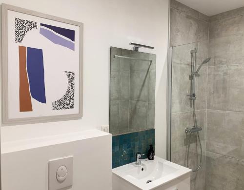a bathroom with a shower and a sink and a shower at Le Patio - Vallée d'Aspe in Bedous