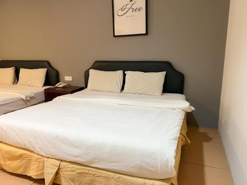 two beds sitting next to each other in a room at N9 Business Hotel Sdn Bhd in Nilai