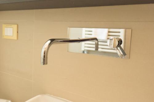 a bathroom sink with a faucet in front of a mirror at Hotel San Francisco in Viareggio