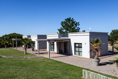 a white building with palm trees in front of it at Casa Chic Carmelo in Carmelo