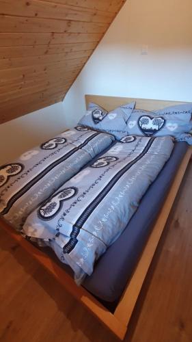 a bed with a blue comforter on top of it at Bright, sunny holiday apartment on the farm in Oberdiessbach