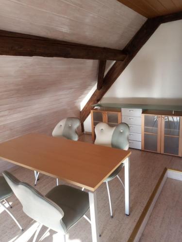a dining room with a wooden table and chairs at Bright, sunny holiday apartment on the farm in Oberdiessbach