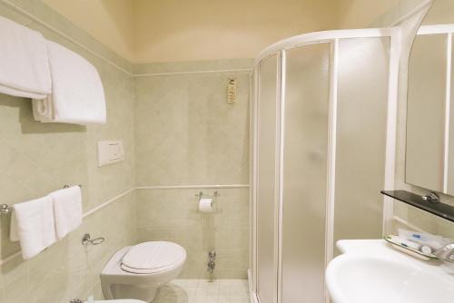 a bathroom with a shower and a toilet and a sink at Hotel San Francisco in Viareggio