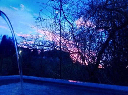 a view of a sunset from a car window at Bright, sunny holiday apartment on the farm in Oberdiessbach