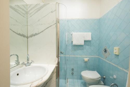 a bathroom with a sink and a toilet and a shower at Hotel San Francisco in Viareggio