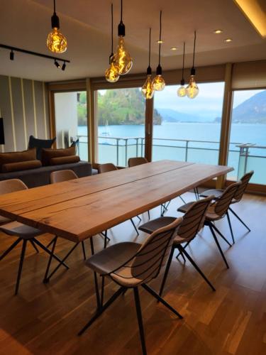 a large wooden table and chairs in a room at Chalet Apartments Iseltwald in Iseltwald