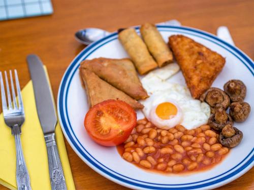 a plate of breakfast food with eggs beans and toast at Corstorphine Lodge Hotel in Edinburgh