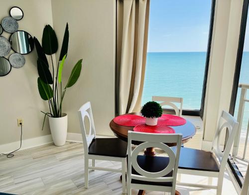 a dining room with a table and a view of the ocean at 1510 Pearl on the Beach Pet Friendly in Myrtle Beach