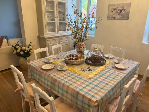 a dining room table with a checked table cloth and a table at Château Ségot in Neuilly-le-Réal