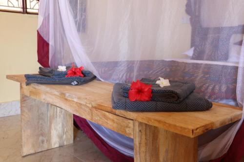 a wooden table with towels on top of it at Tipitipi house in Kizimkazi