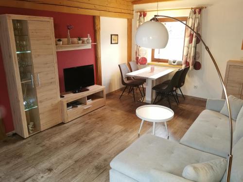 a living room with a couch and a table at Ferienwohnung Adrowitzer in Lofer
