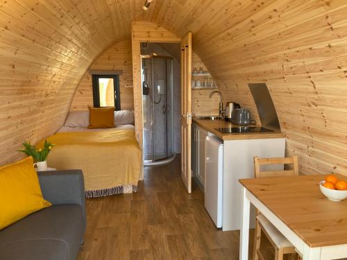 a small room with a bed in a tiny house at Kirkapol Beach Pod - Ebb in Middleton