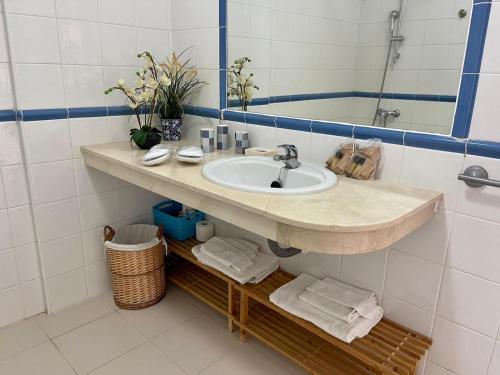 a bathroom with a sink and a mirror at Balcon del Mar A&V Ocen View Costa del Silencio in Costa Del Silencio