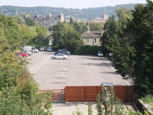 a parking lot with cars parked in it at Elgin Villa in Bath
