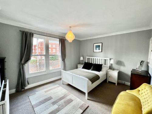 a bedroom with a white bed and a window at 14 Union Road in Lincolnshire