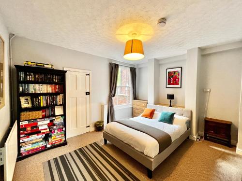 a bedroom with a bed and a book shelf at 14 Union Road in Lincolnshire