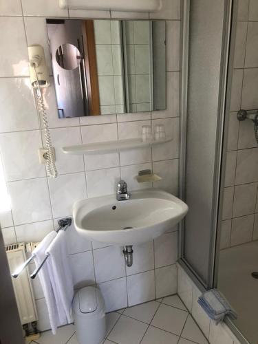 a bathroom with a sink and a mirror at Brauereigasthof Hotel Schlüssel in Giengen an der Brenz