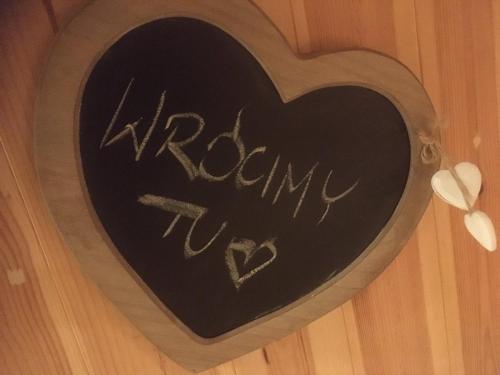 a heart shaped sign with the word mom written on it at Kamień na Kaszubach in Kamień