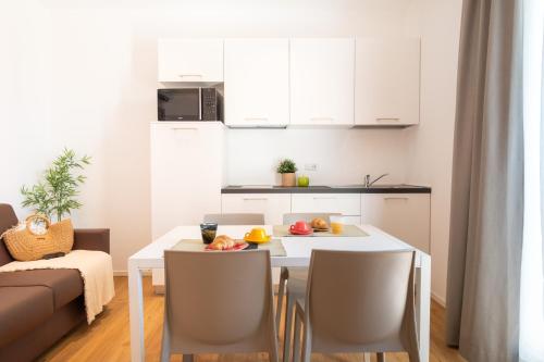 a small kitchen with a table with fruit on it at Superior Beach Aparthotel in Lido di Jesolo