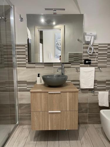 a bathroom with a sink and a mirror at AC HOME in Catania